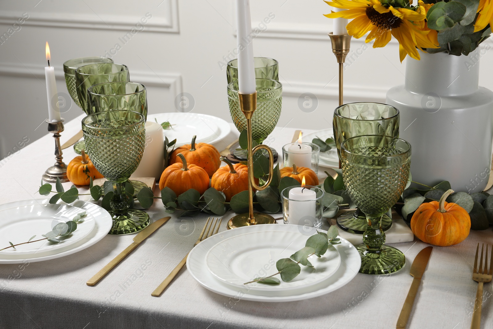 Photo of Beautiful autumn table setting with bouquet indoors. Plates, cutlery, glasses and floral decor