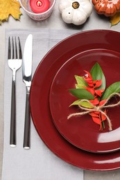 Photo of Beautiful place setting with autumn decor on grey table, flat lay