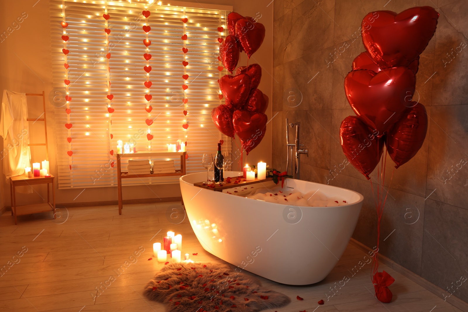 Photo of Stylish bathroom decorated for Valentine's day. Interior design