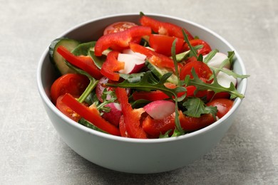 Photo of Tasty fresh vegetarian salad on light grey table, closeup