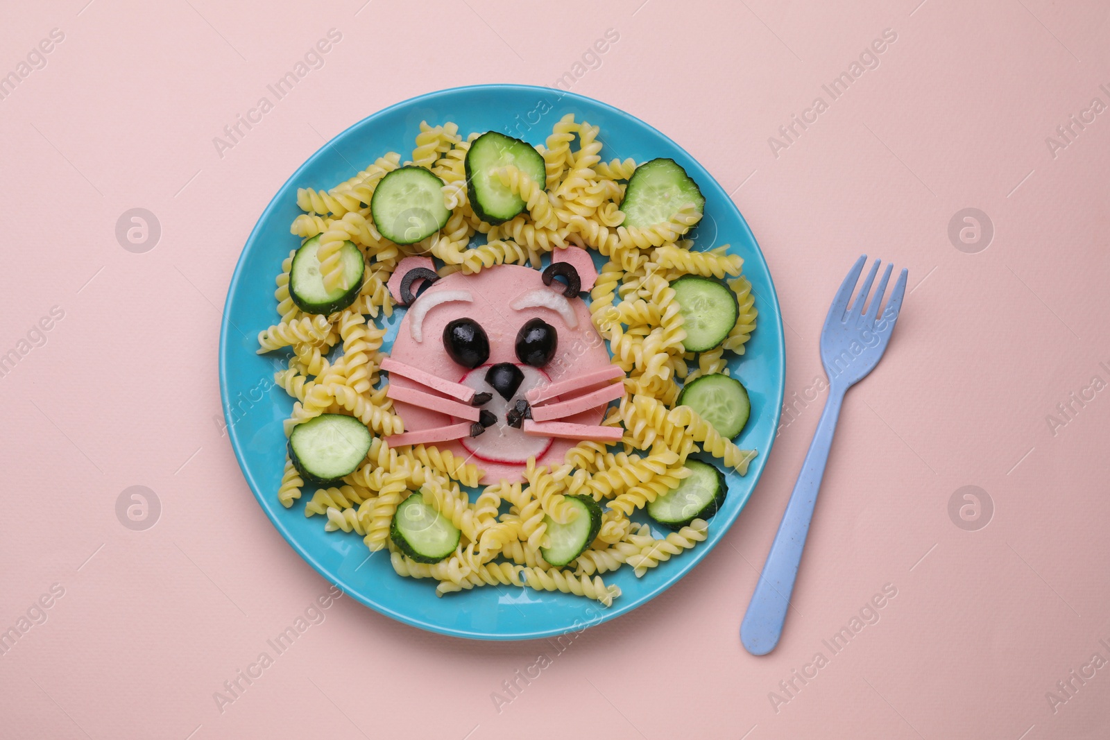 Photo of Creative serving for kids. Plate with cute bear made of tasty pasta, vegetables and sausage on beige background, flat lay