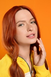 Photo of Portrait of beautiful woman on orange background