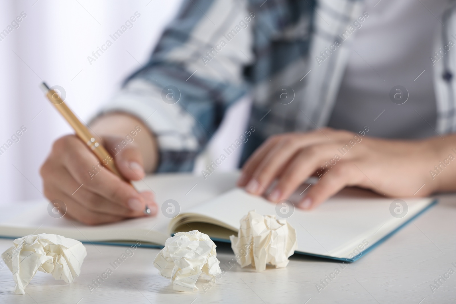 Photo of Woman working at table with crumpled paper, closeup. Generating idea