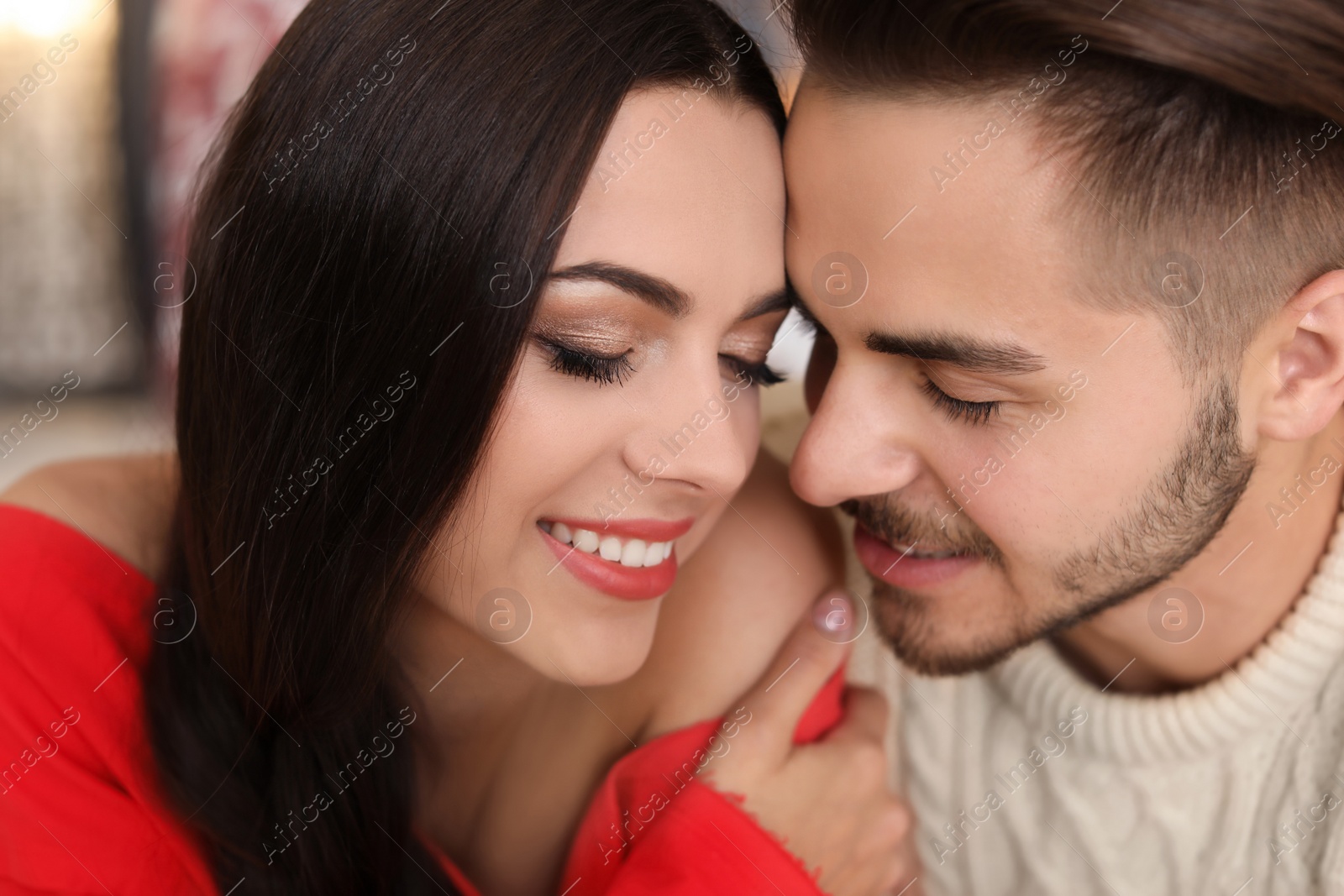 Photo of Happy young couple celebrating Christmas at home