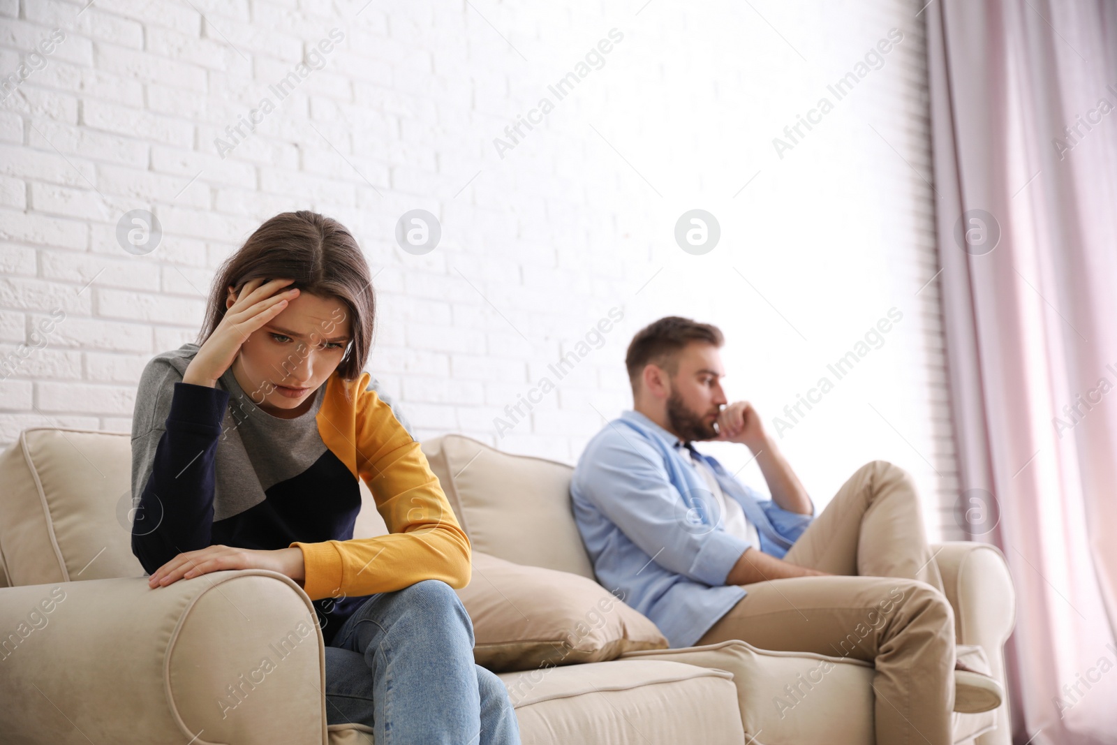 Photo of Unhappy couple with problems in relationship at home