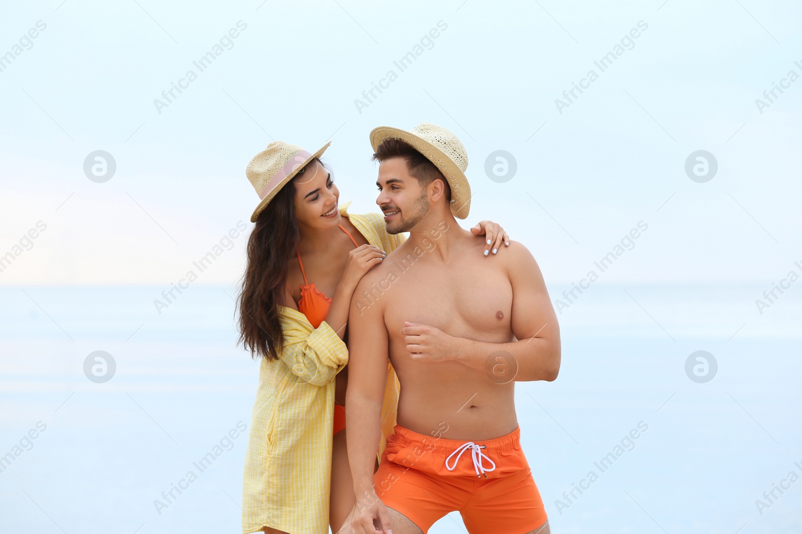 Photo of Happy young couple spending time together on beach