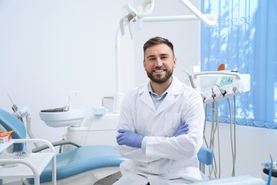 Portrait of professional dentist at workplace in clinic