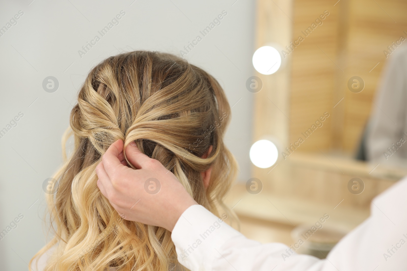 Photo of Hair styling. Professional hairdresser working with client in salon, closeup