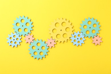 Business process organization and optimization. Scheme with colorful figures on yellow background, top view