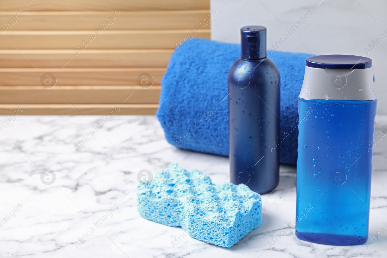 Photo of Cosmetic products and towel on white marble table. Men's hygiene