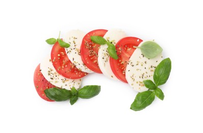 Photo of Tasty salad Caprese with mozzarella, tomatoes, basil and spices on white background, top view