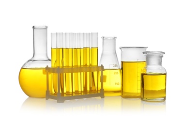 Photo of Laboratory glassware with yellow liquid on white background