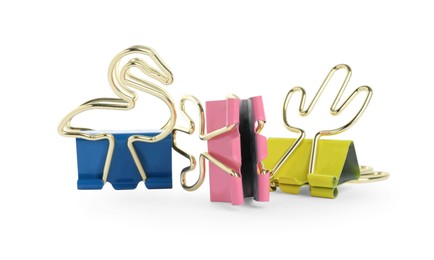 Different colorful binder clips on white background. Stationery item