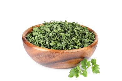 Bowl with dried parsley and fresh twig on white background