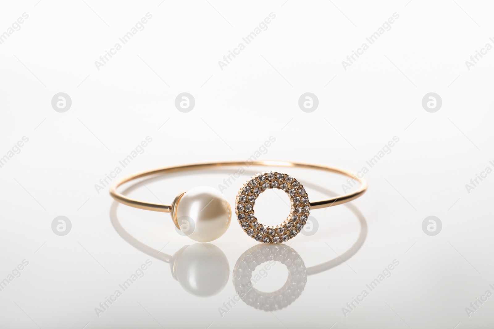 Photo of Elegant golden bracelet with pearl isolated on white