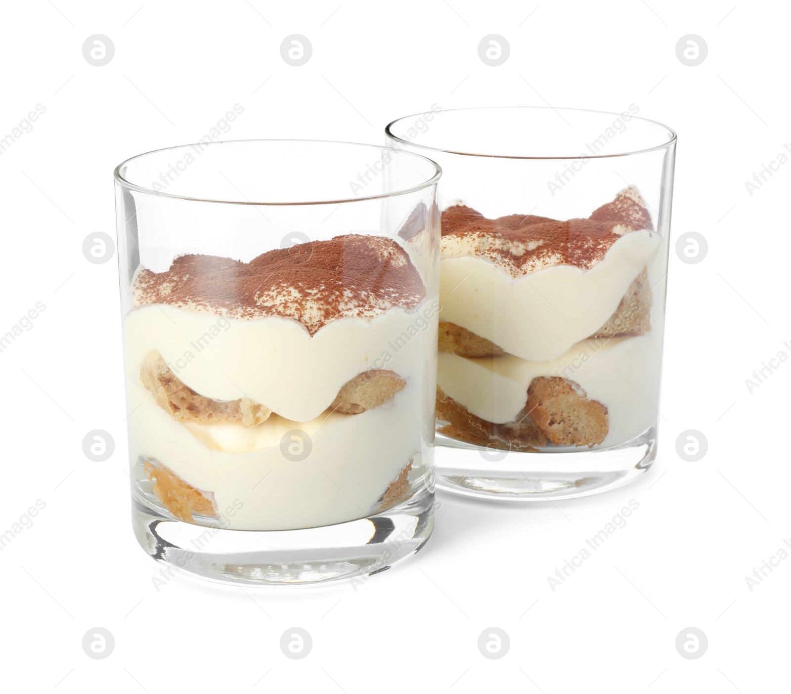 Photo of Delicious tiramisu in glasses isolated on white