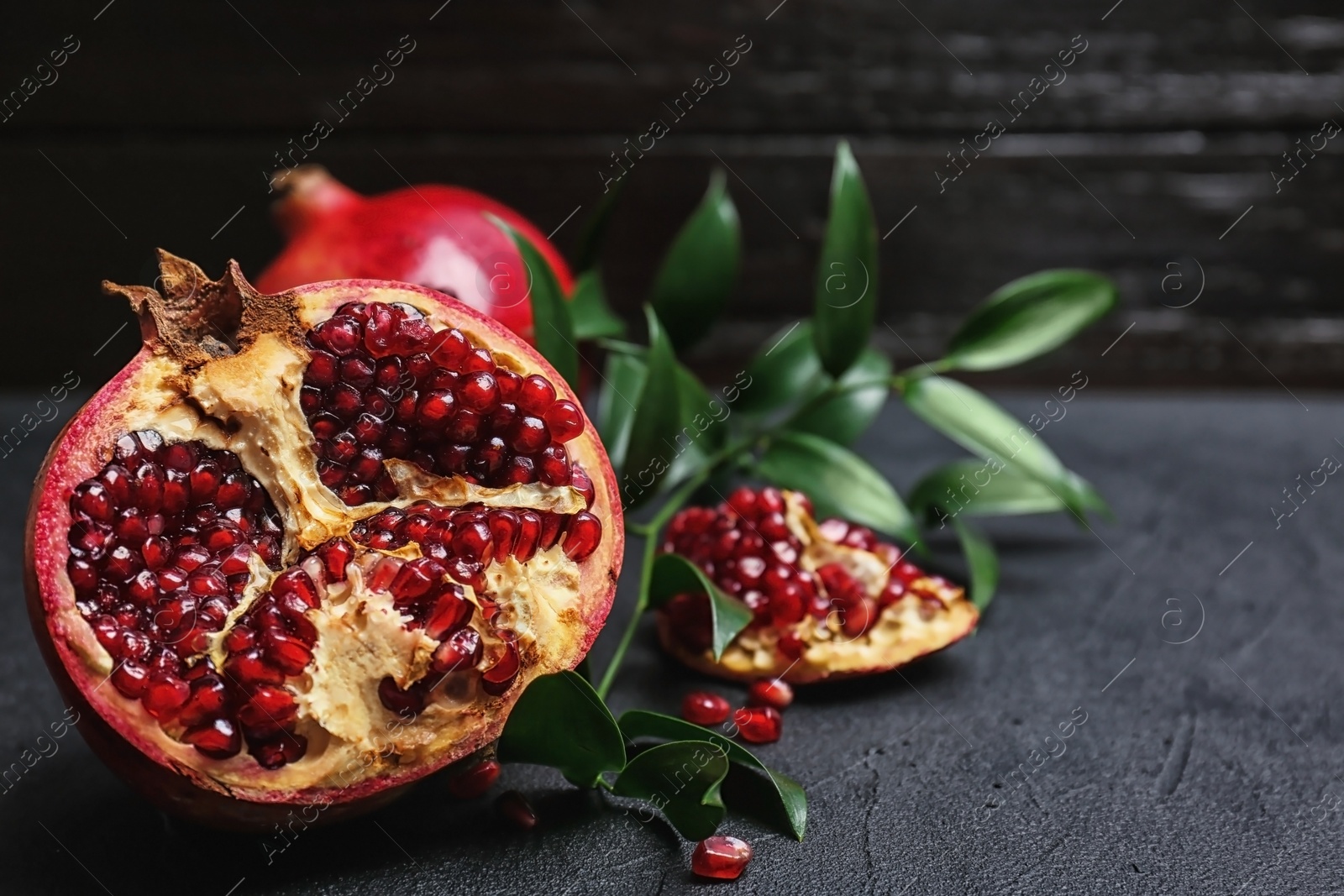 Photo of Fresh yummy pomegranate on dark table