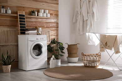 Stylish room interior with washing machine. Design idea