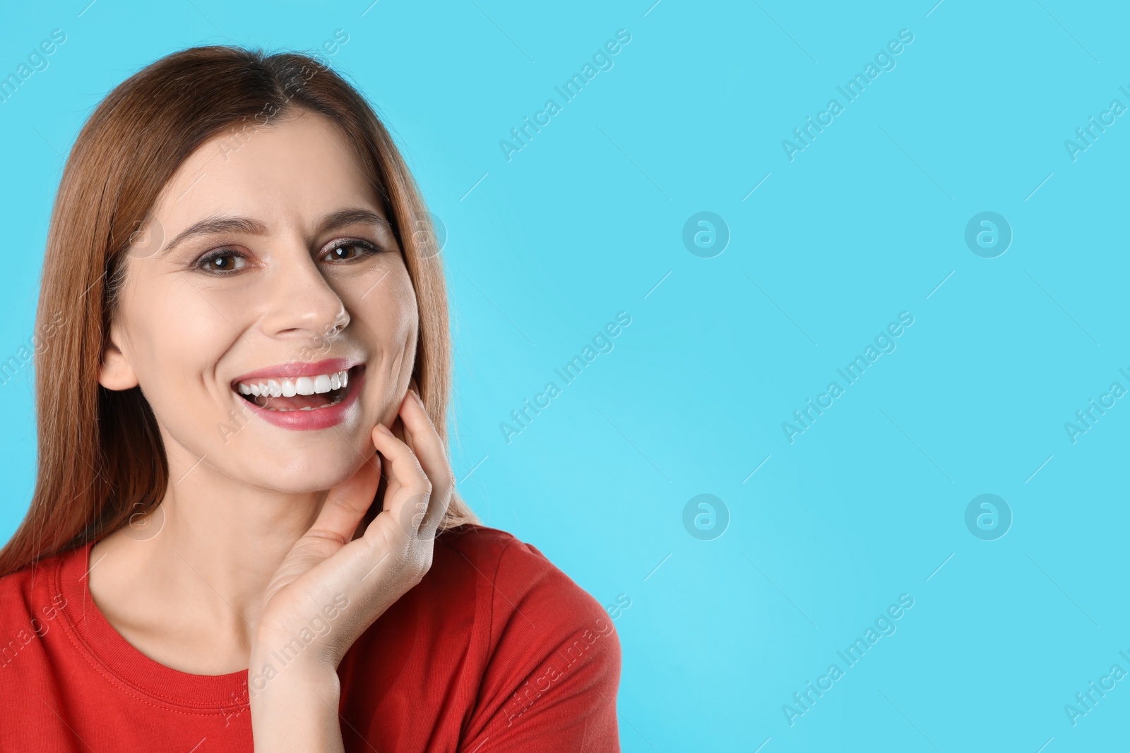 Photo of Smiling woman with perfect teeth on color background. Space for text