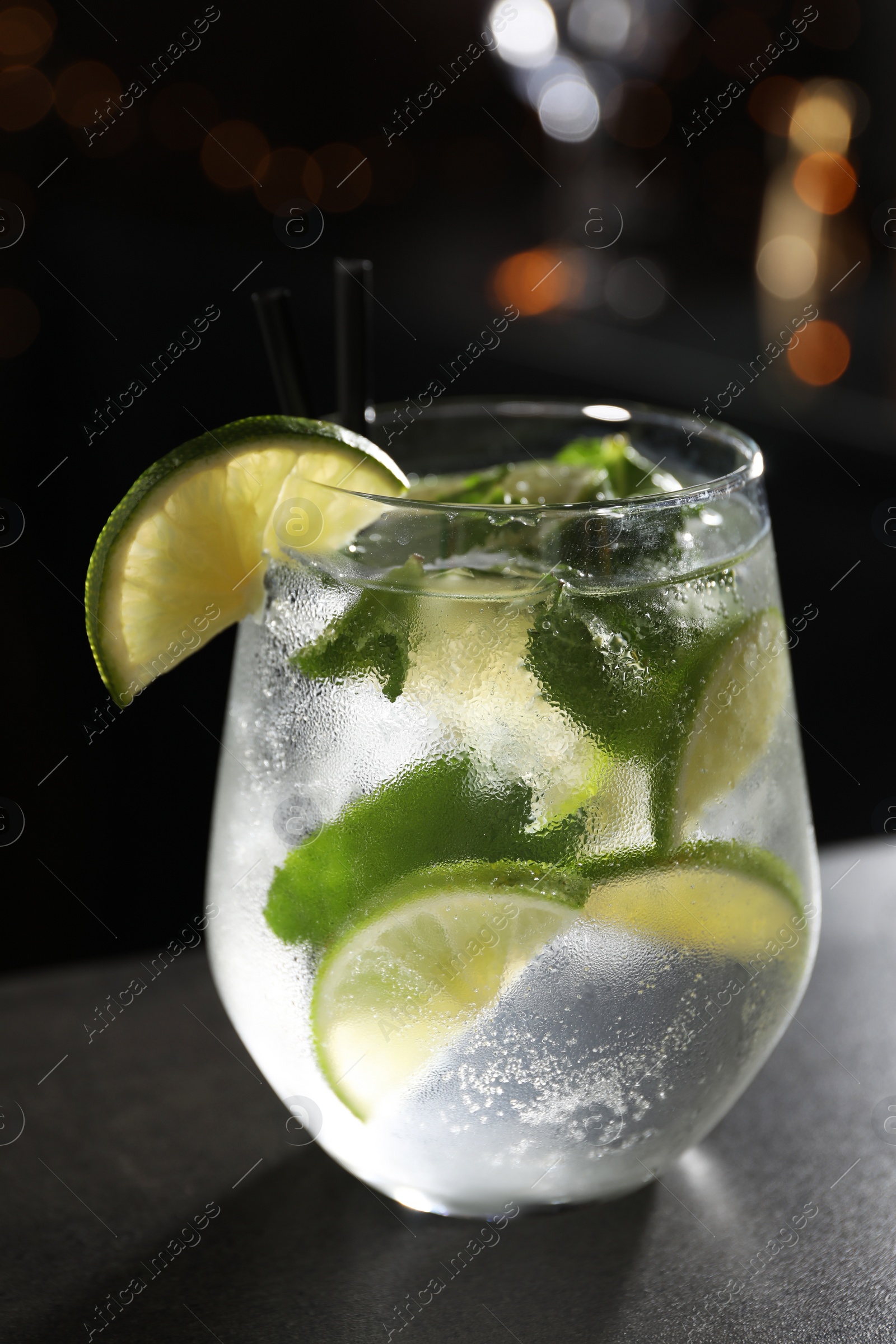 Photo of Glass of fresh alcoholic cocktail on bar counter, closeup