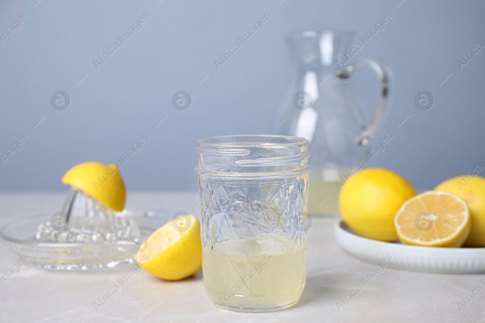 Photo of Freshly squeezed lemon juice on light table