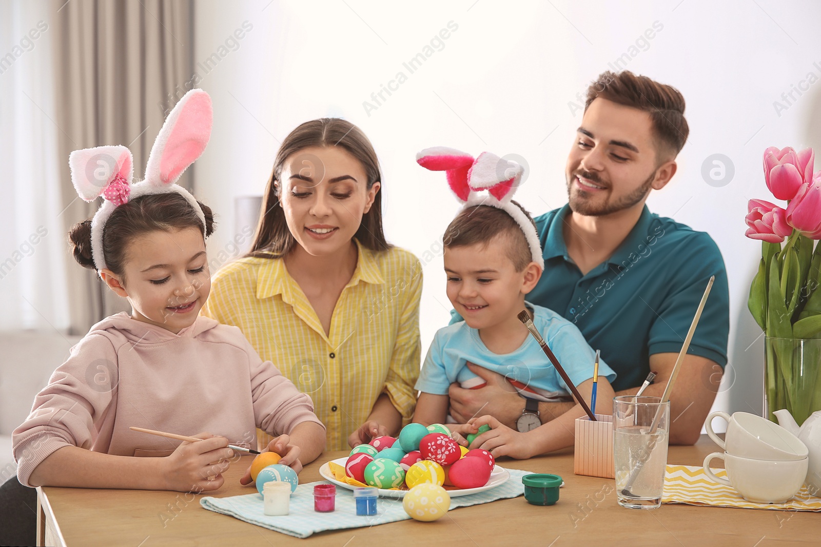 Photo of Happy family with Easter eggs at home. Festive tradition