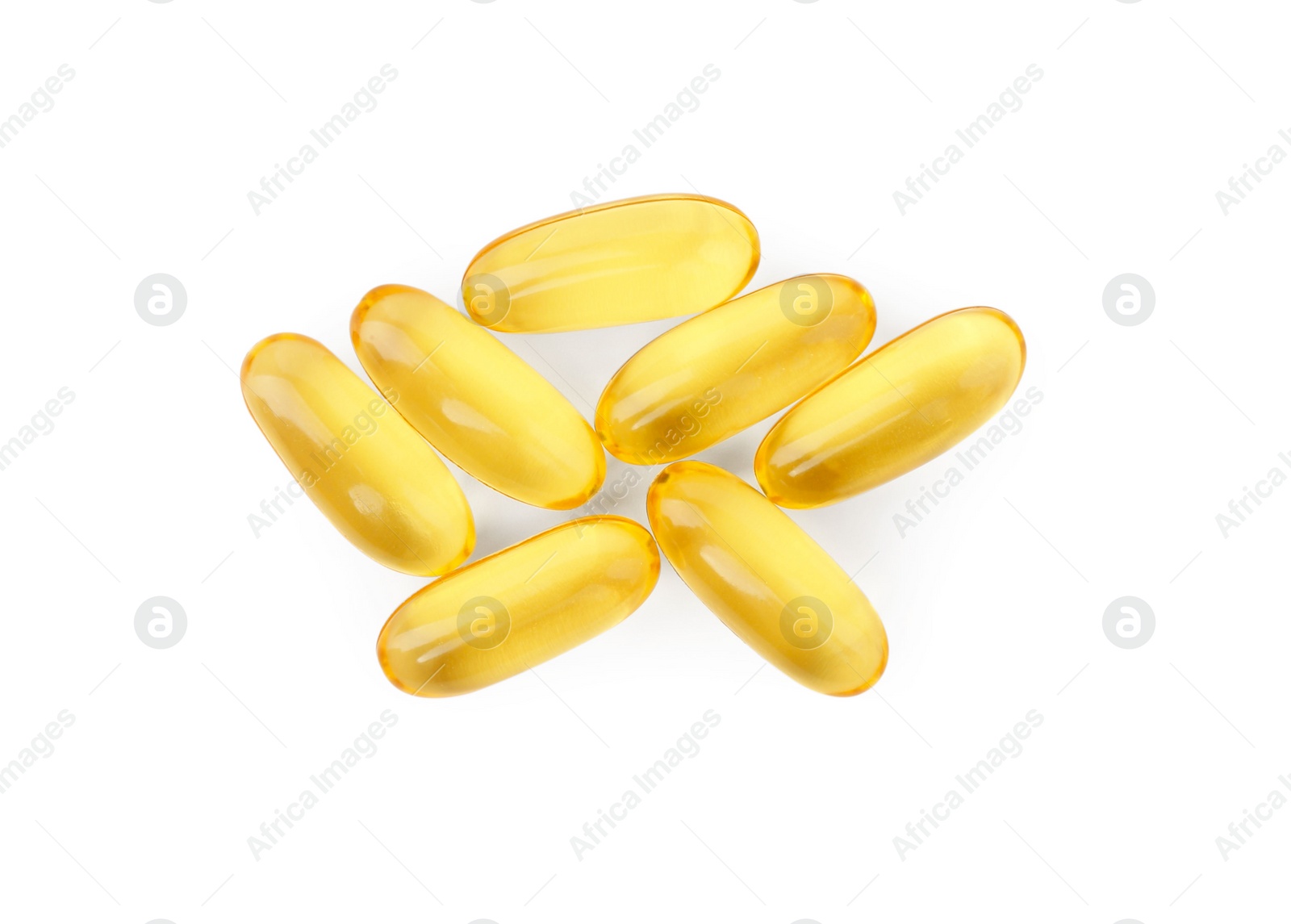 Photo of Many yellow vitamin capsules isolated on white, top view