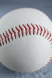 Photo of Baseball ball on grey table, closeup view