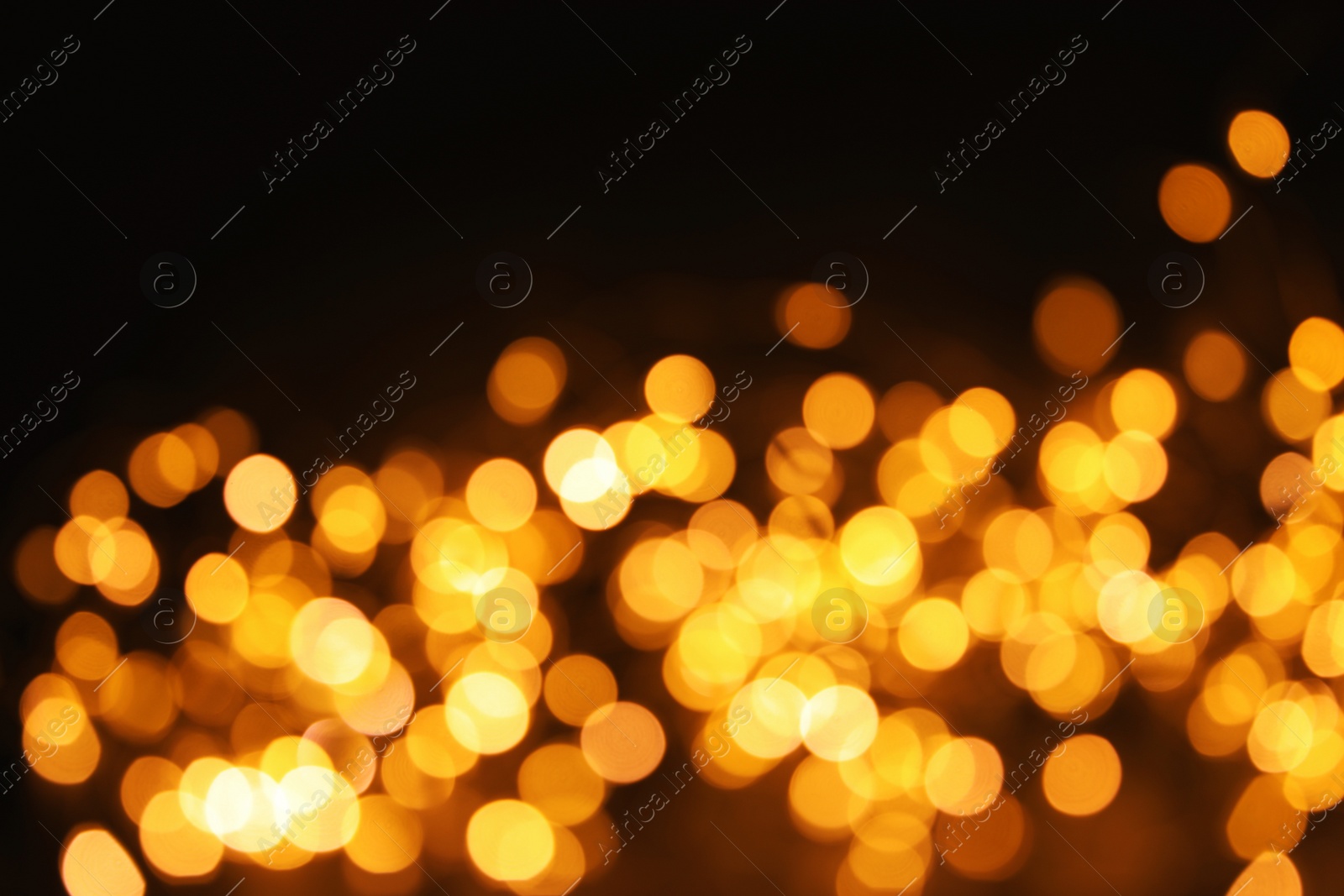 Photo of Gold glitter with bokeh effect on dark background