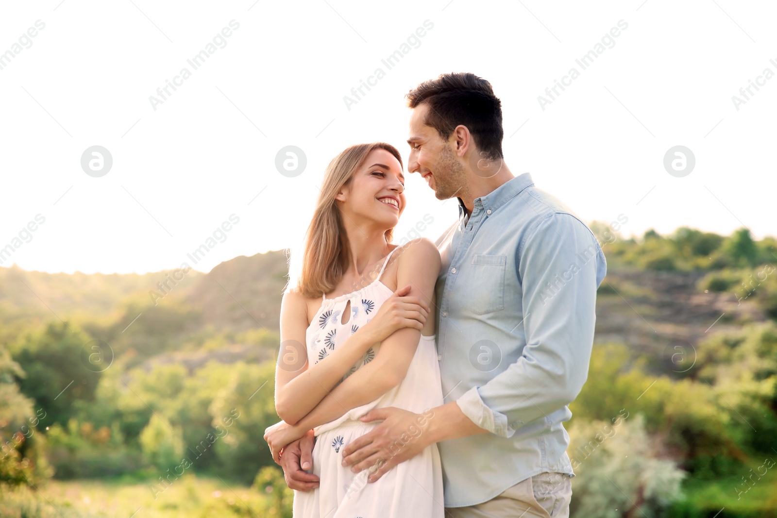 Photo of Cute young couple in love posing outdoors on sunny day