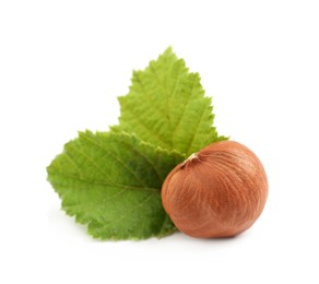 Photo of Tasty organic hazelnut and leaves on white background