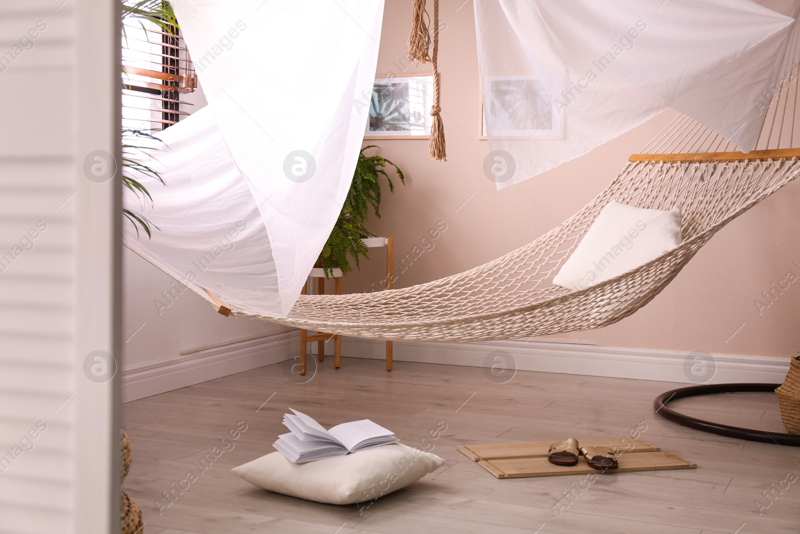 Photo of Comfortable hammock in stylish room. Interior design