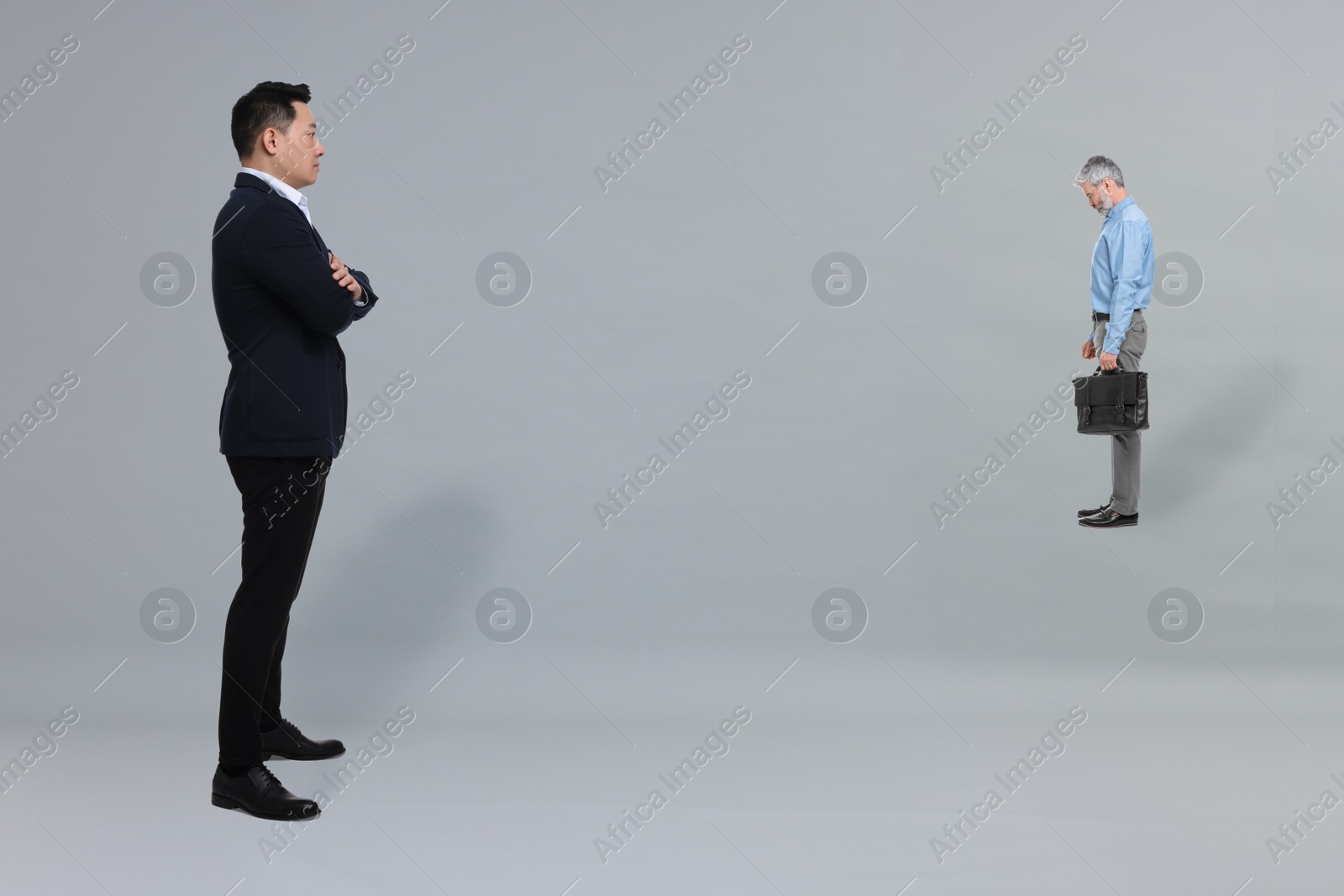 Image of Giant boss and sad small man on grey background