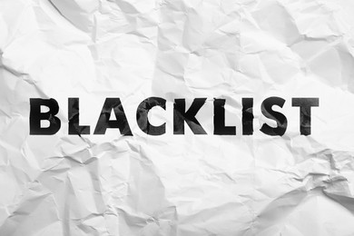 Black word Blacklist on crumpled white paper