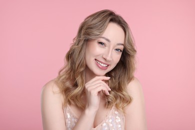 Photo of Portraitsmiling woman on pink background
