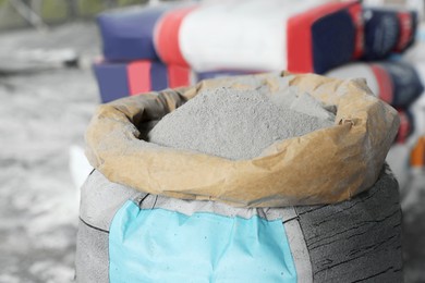Photo of Cement powder in bag indoors, closeup view