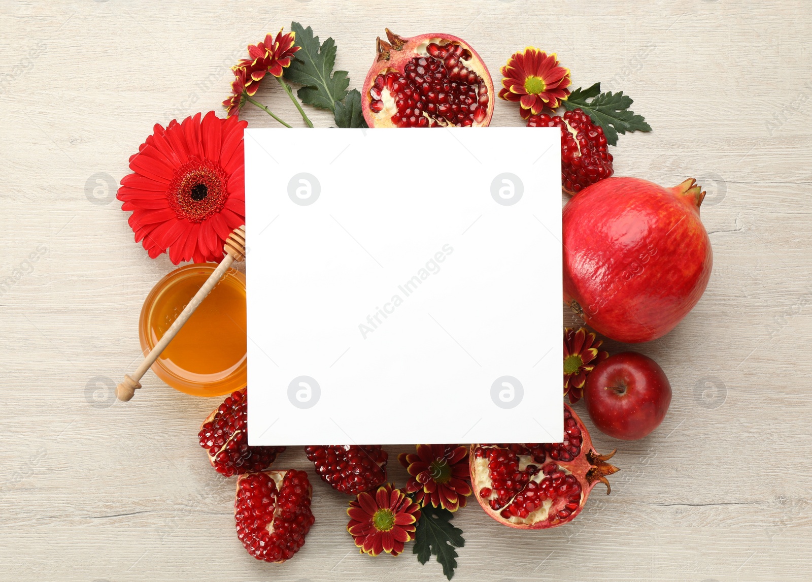 Photo of Flat lay composition with Rosh Hashanah holiday attributes and card on white wooden table. Space for text