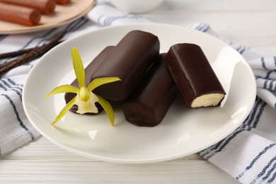 Photo of Glazed vanilla curd cheese bars served on white wooden table, closeup