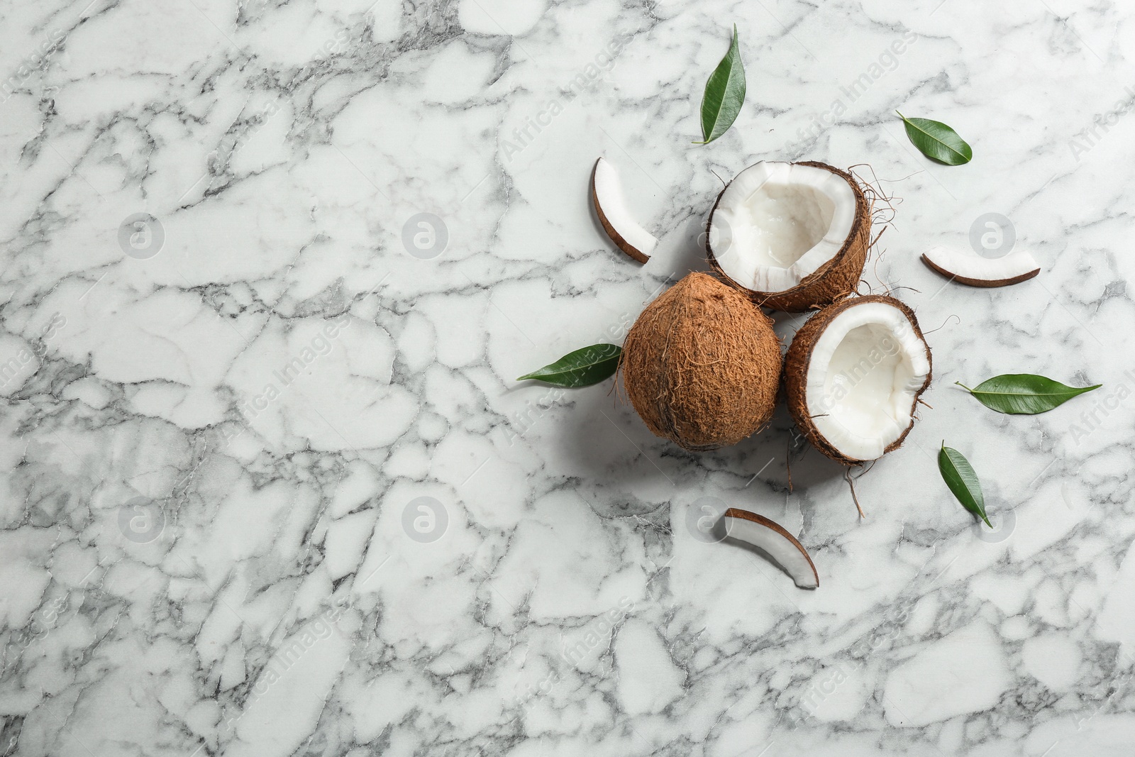 Photo of Flat lay composition with coconuts a on marble table. Space for text