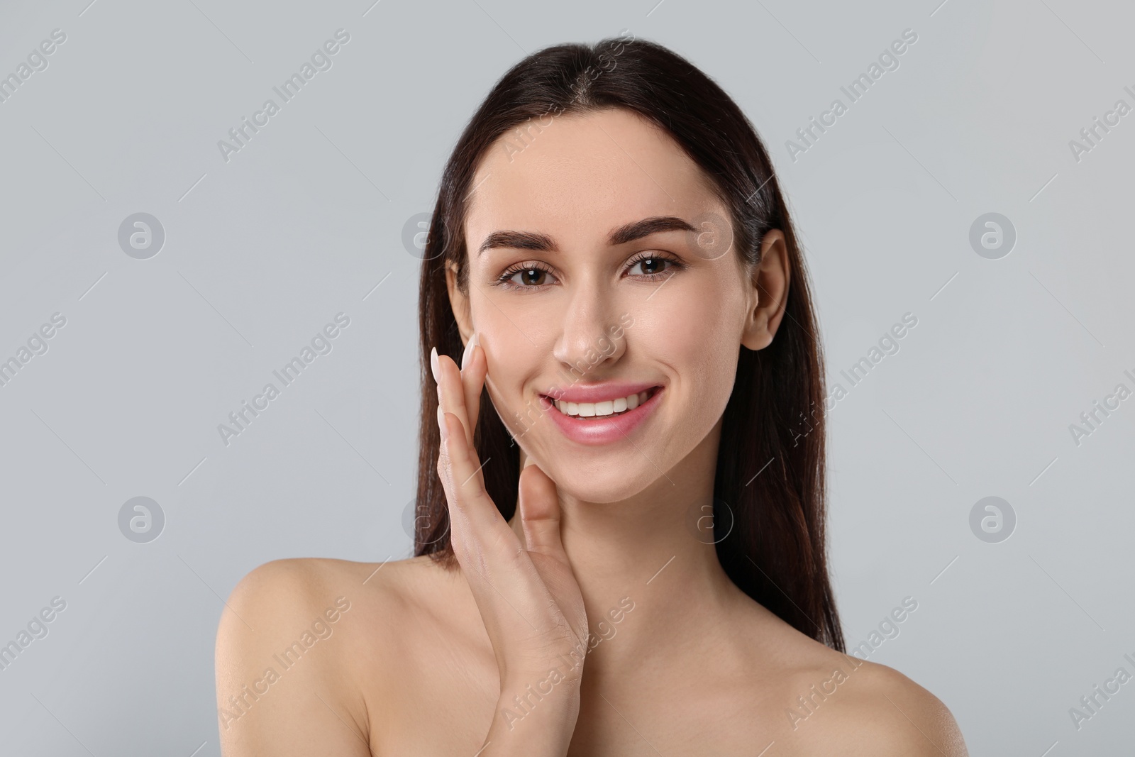 Photo of Portrait of beautiful young woman on light grey background