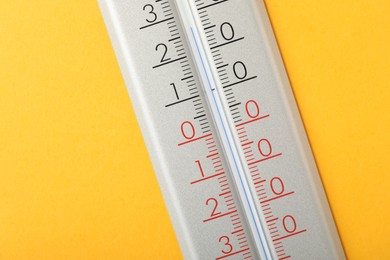 Modern weather thermometer on yellow background, closeup