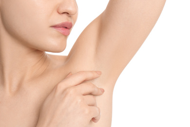 Photo of Young woman showing armpit with smooth clean skin on white background, closeup