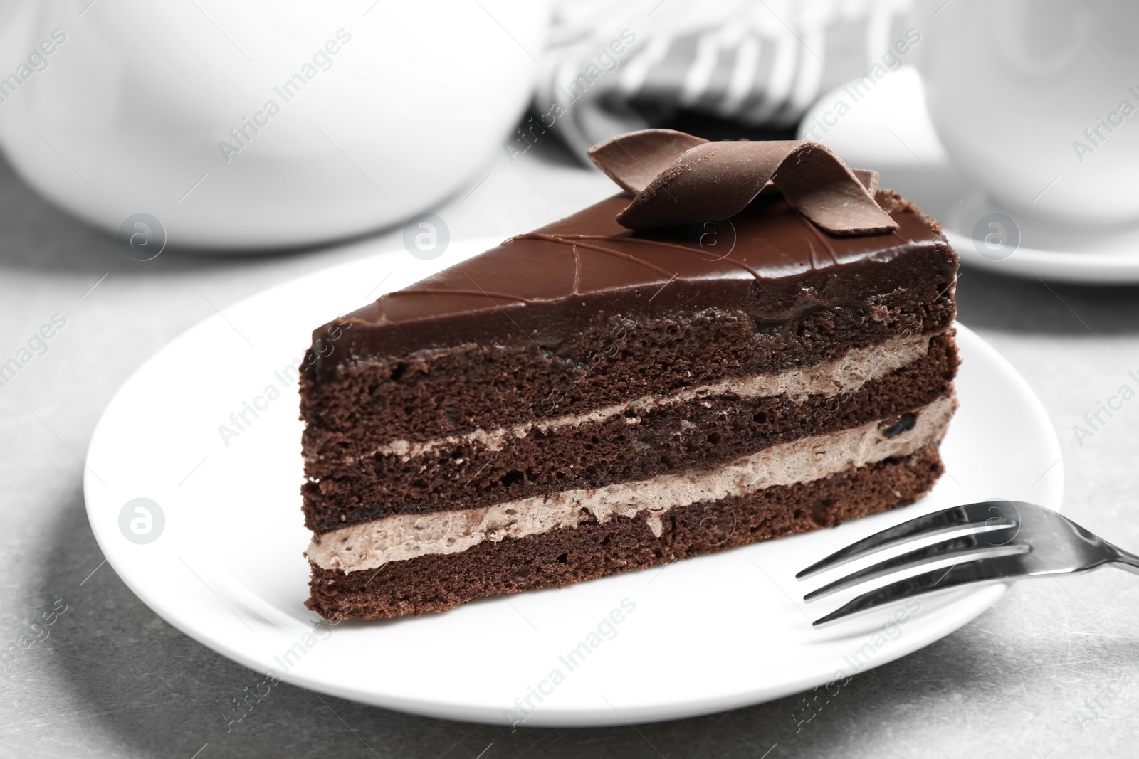 Photo of Delicious fresh chocolate cake served on table, closeup