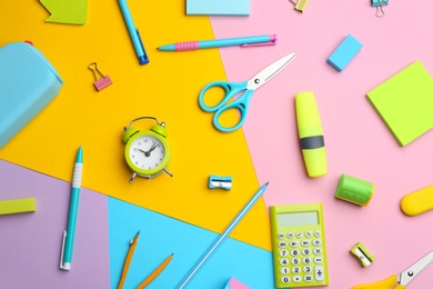 Photo of Different bright school stationery on color background, flat lay