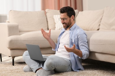 Man having video chat via laptop at home