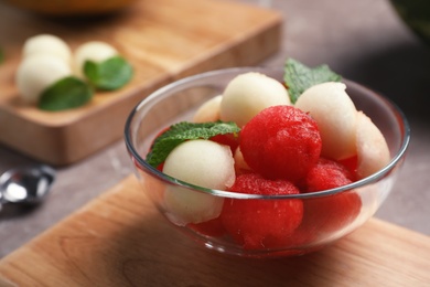 Bowl with melon and watermelon balls on table