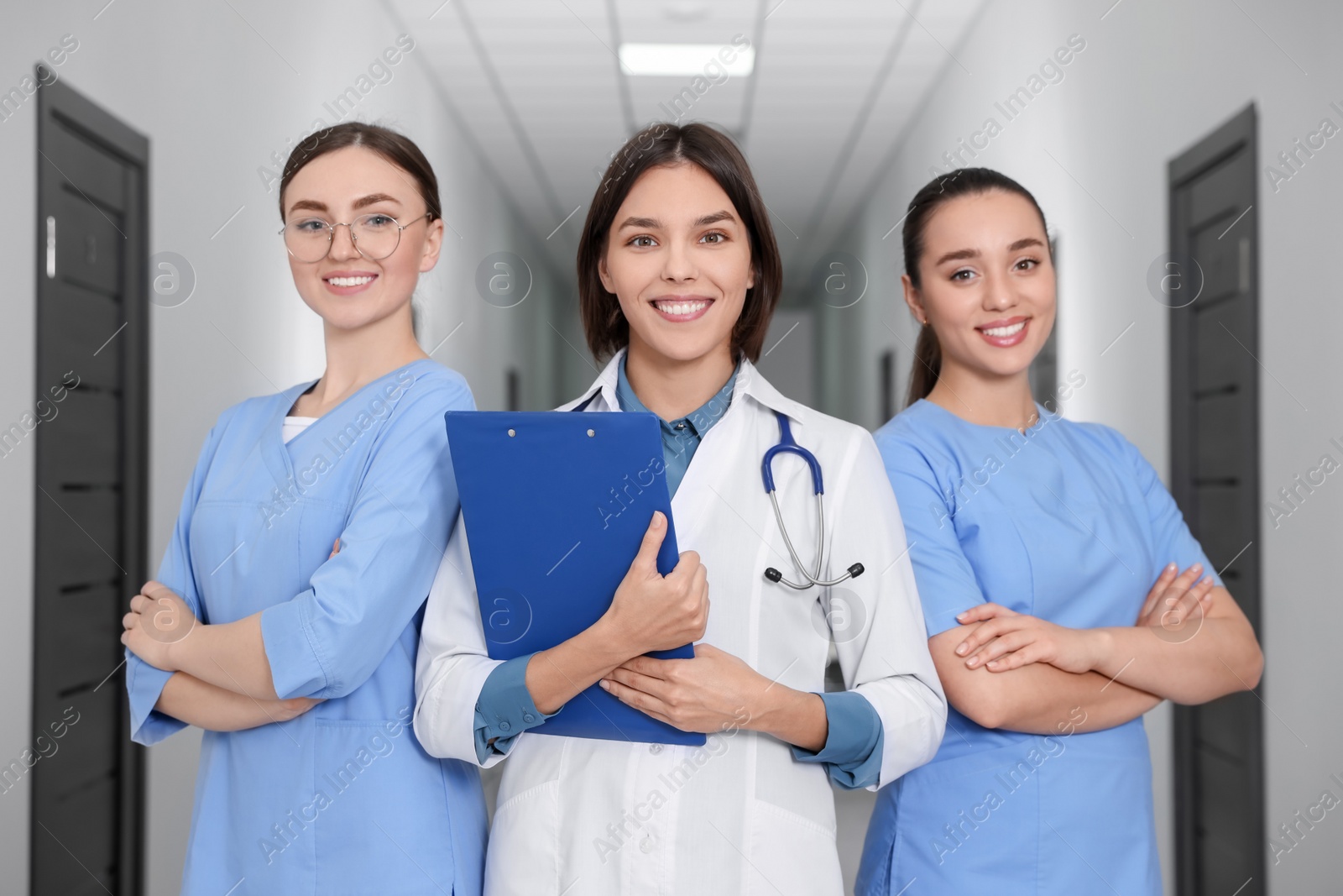 Photo of Team of professional doctors in clinic hallway