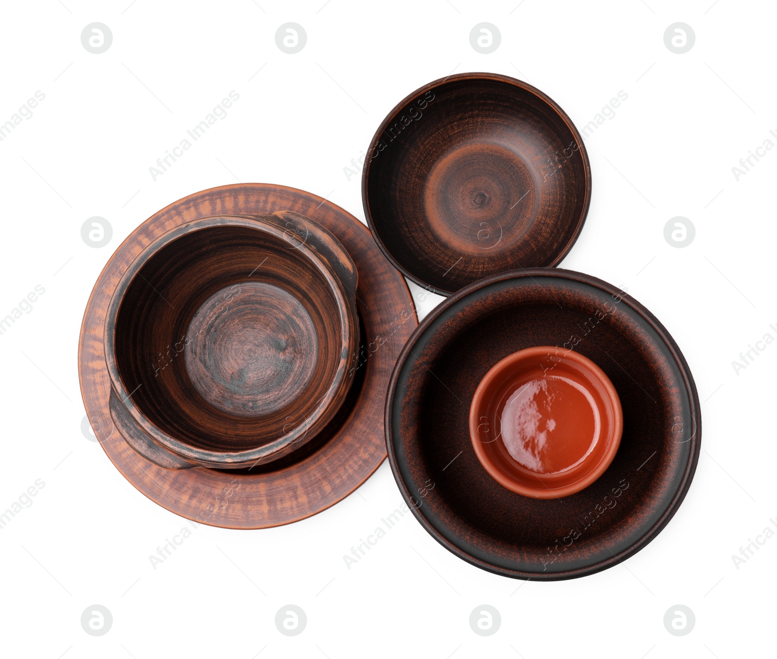 Photo of Set of clay dishes isolated on white, top view. Cooking utensils