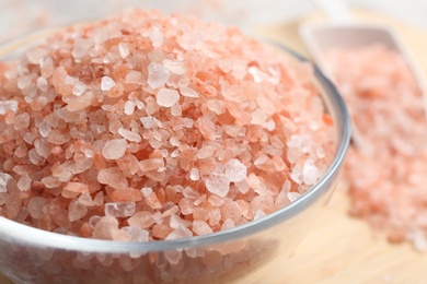Photo of Pink himalayan salt in glass bowl on table, closeup