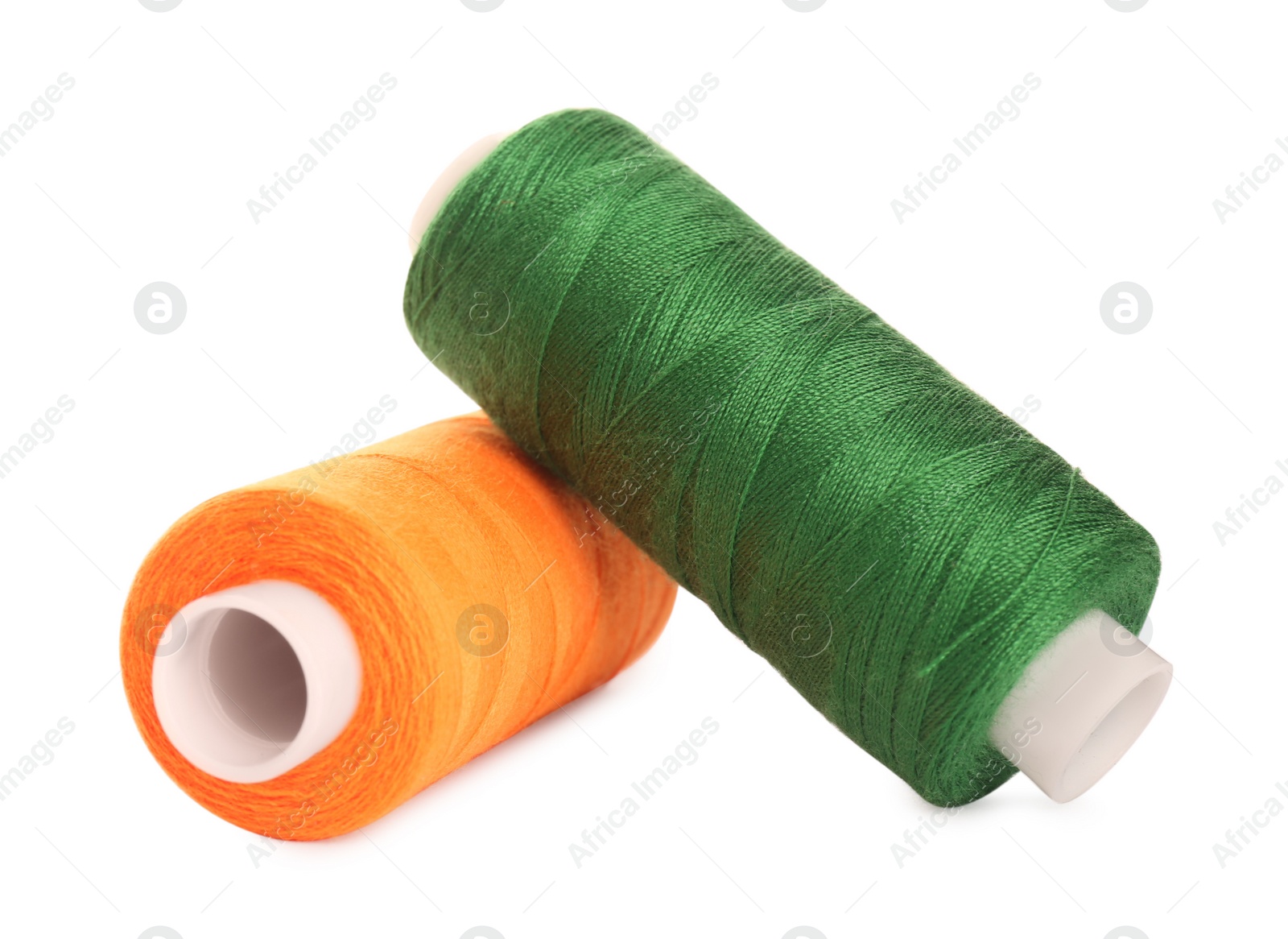 Photo of Different colorful sewing threads on white background, closeup